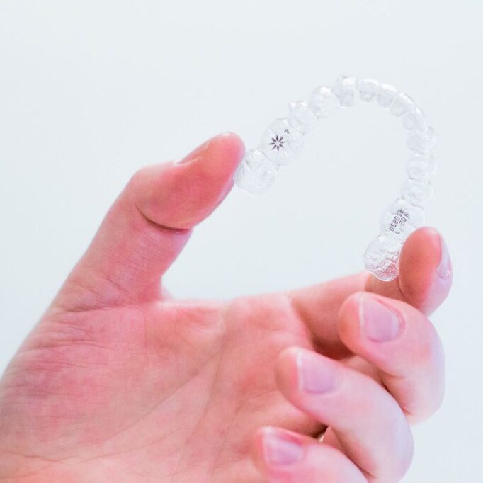 hand-holding-invisalign-aligners Worchester Invisalign